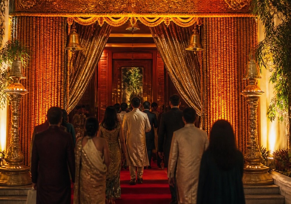 Marigold garland curtain and gold arch at a Bollywood theme party entrance